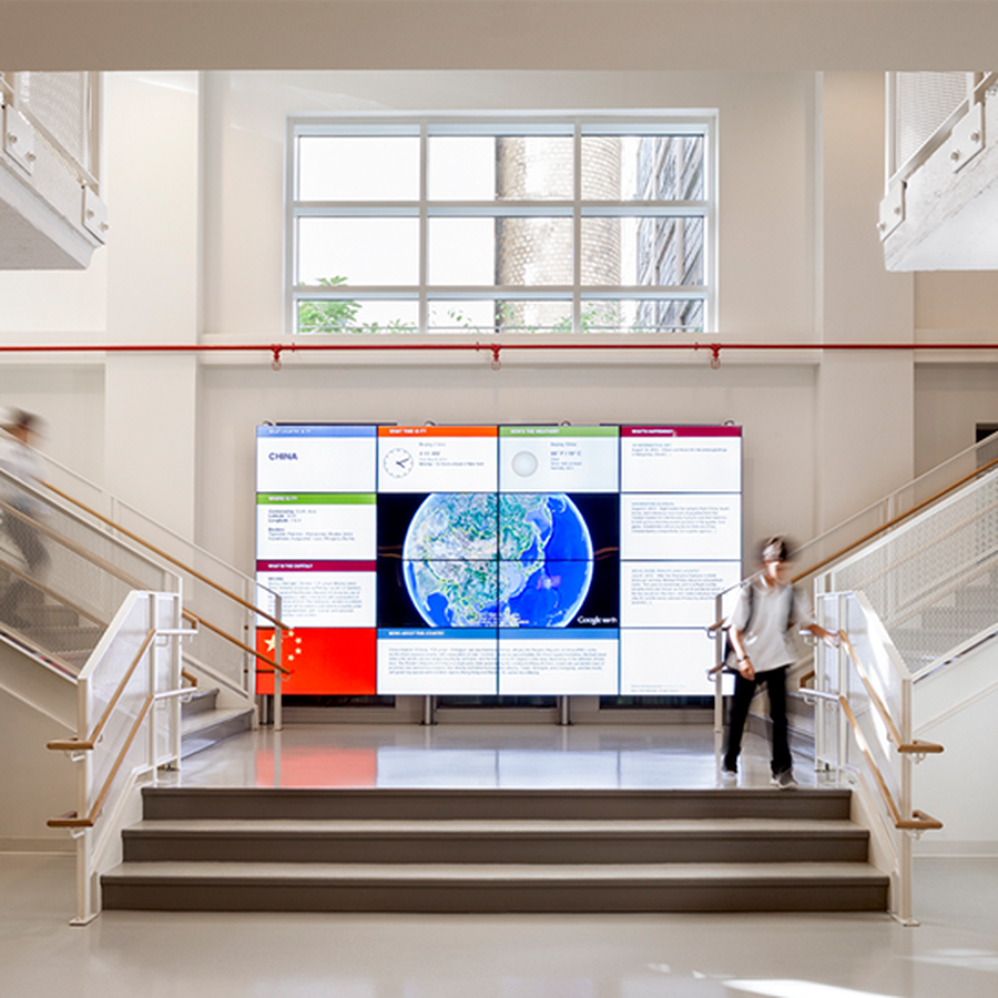 New York campus lobby with staircase and video wall